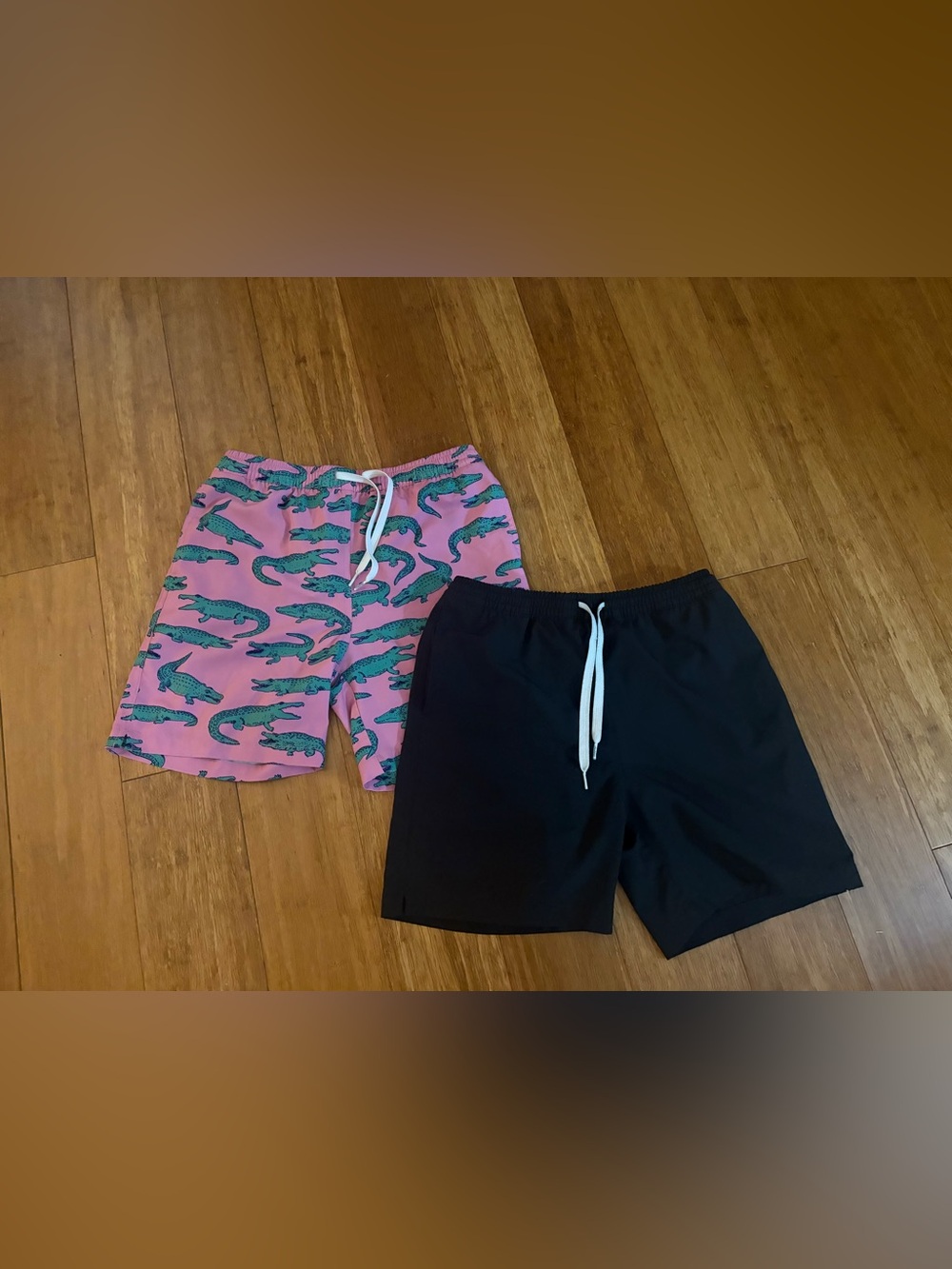 Chubbies 
1 Pink Crocodile Print & 1 Black swim trunk
Boys Large